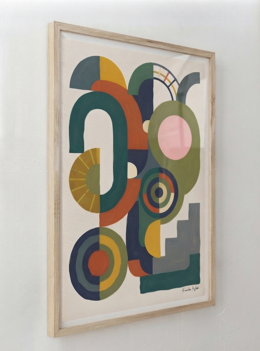 A framed  Bauhaus Abstract Geometric Wall Poster with bold color block art print composition by Francis Phylae for Phylae Posters, featuring mid-century modern geometric shapes in teal, olive green, orange, yellow, pink, and gray on a cream background, housed in a light natural wood frame and hung on a white wall.