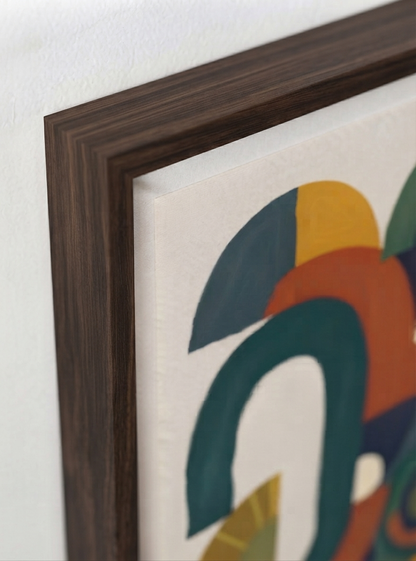 Close-up of a framed Bauhaus Abstract Geometric Wall Poster featuring architectural shapes poster design with geometric abstraction by Francis Phylae at Phylae Posters with a dark brown wood frame, featuring geometric shapes in teal, orange, yellow, and navy on a white background.