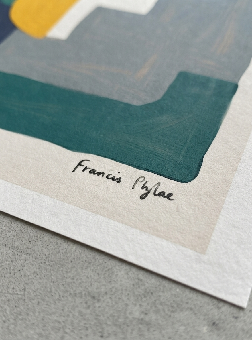 Close-up of an Bauhaus Abstract Geometric Wall Poster featuring aesthetic minimal block print art with architectural forms by Francis Phylae at Phylae Posters, on textured paper, featuring geometric shapes in teal, gray, cream, and yellow, with the signature 'Francis Phylae' written in black ink on a gray surface.