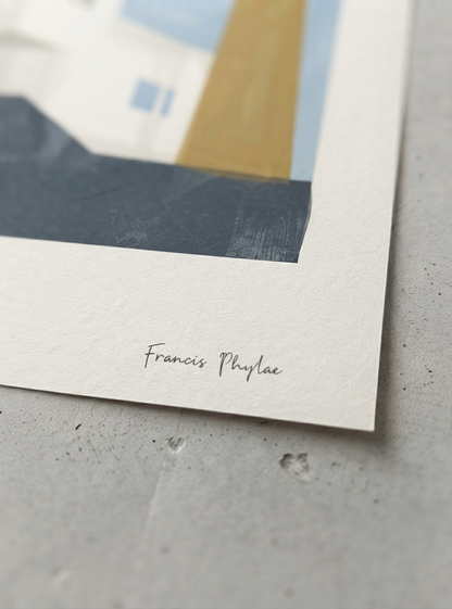 A close-up of a Bauhaus Geometric House Poster with sophisticated sage green and blue abstract forms for modern home décor by Phylae Posters on textured white paper, showing part of a minimalist geometric scene with blue, white, tan, and dark gray blocks, plus the handwritten name 'Francis Phylae' near the bottom. The paper rests on a light gray surface.