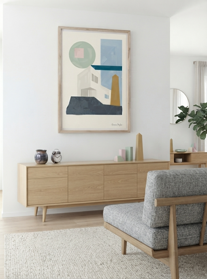 A framed  Geometric Art Poster inspired by Bauhaus architecture with neutral tones, sage green and blue accents, from an original acrylic painting by Francis Phylae.hangs on a white wall above a light wood sideboard in a bright, modern living room. The print features shapes and architectural forms in muted blue, green, beige, and yellow tones.