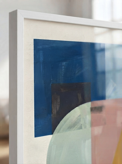 A close-up of a framed Mid-Century Modern Geometric Landscape Art Print displaying geometric forms wall art inspired by original acrylic artwork from Francis Phylae at Phylae Posters with a white frame, featuring geometric shapes in blue, pink, and pale green on a textured off-white background.